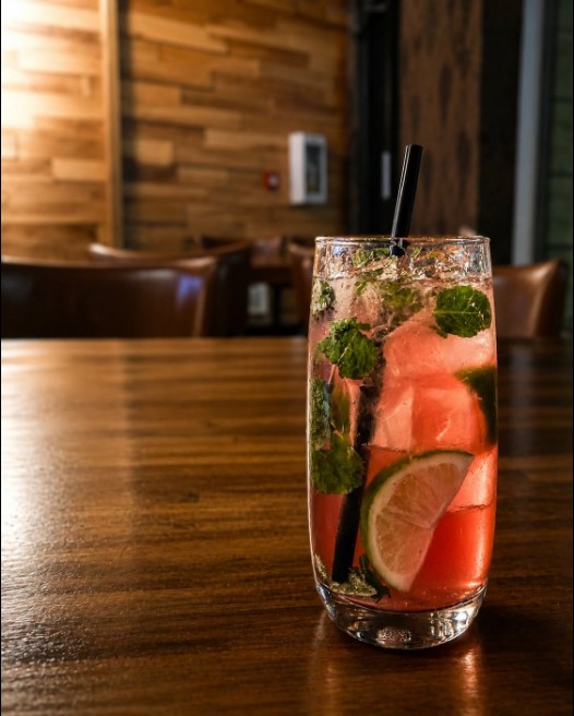 Tall pink drink with lime and mint